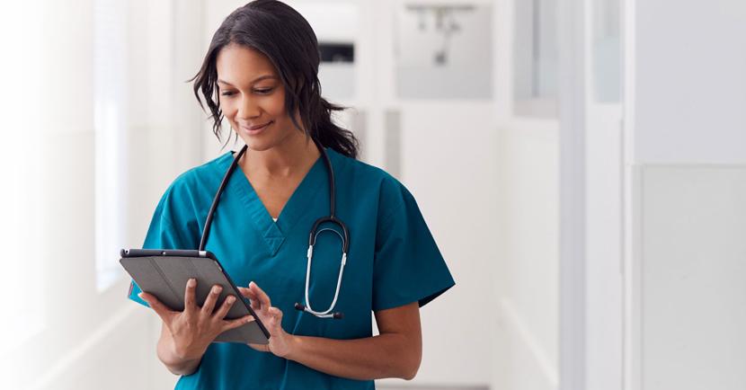 female nurse looking at tablet